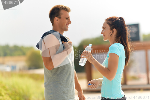 Image of couple with bottle of water after doing sports