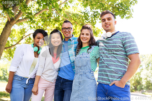 Image of happy international friends in park