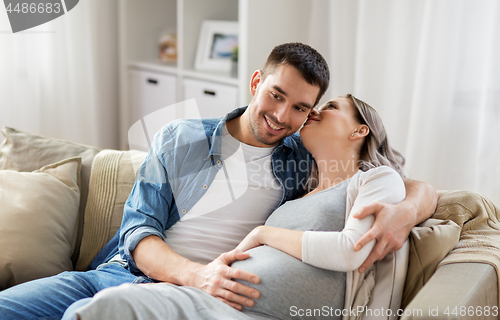 Image of man hugging pregnant woman at home