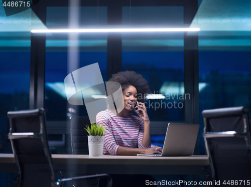 Image of black businesswoman using a laptop in startup office