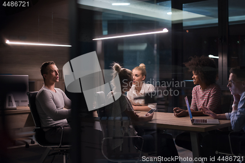 Image of Multiethnic startup business team in night office