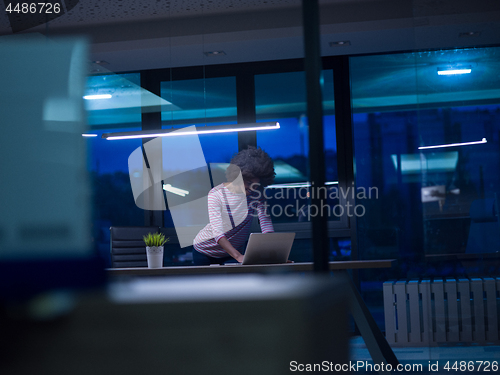 Image of black businesswoman using a laptop in startup office