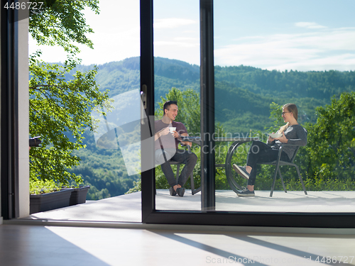 Image of couple enjoying morning coffee and breakfast