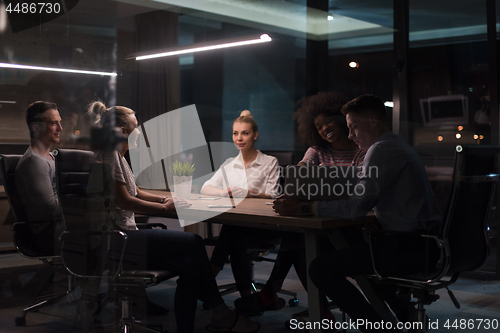 Image of Multiethnic startup business team in night office