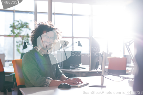 Image of businessman working using a computer in startup office