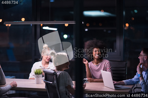 Image of Multiethnic startup business team in night office