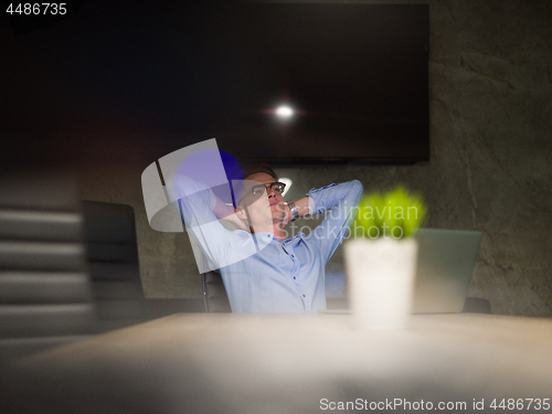 Image of businessman relaxing at the desk