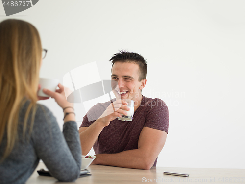 Image of couple enjoying morning coffee and strawberries