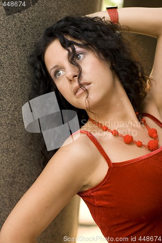 Image of brunette near stone wall