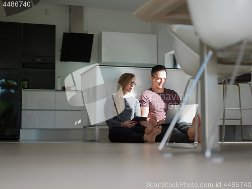 Image of couple using tablet and laptop computers