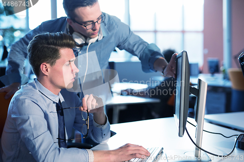 Image of Two Business People Working With computer in office