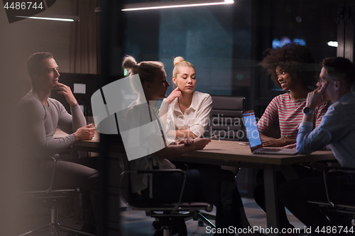 Image of Multiethnic startup business team in night office