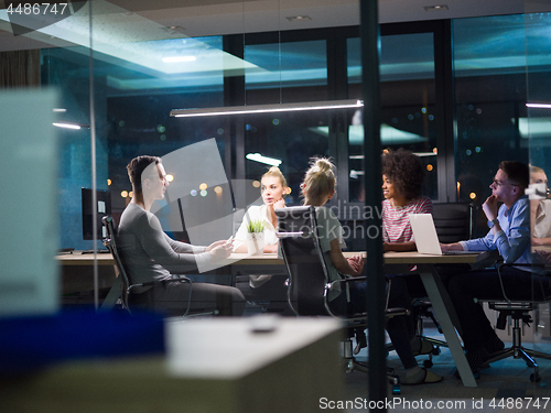 Image of Multiethnic startup business team in night office