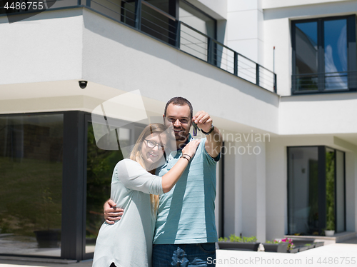 Image of couple hugging in front of  new luxury home