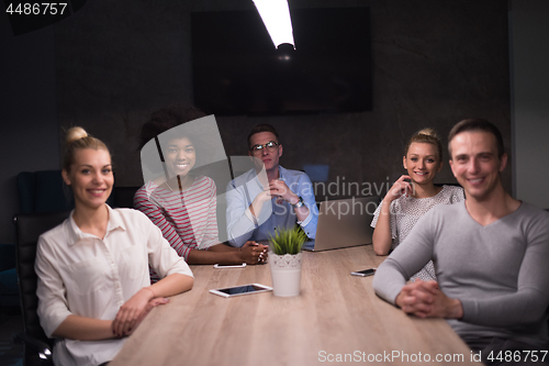 Image of Multiethnic startup business team in night office