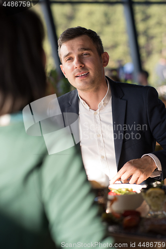 Image of Closeup shot of young woman and man having meal.