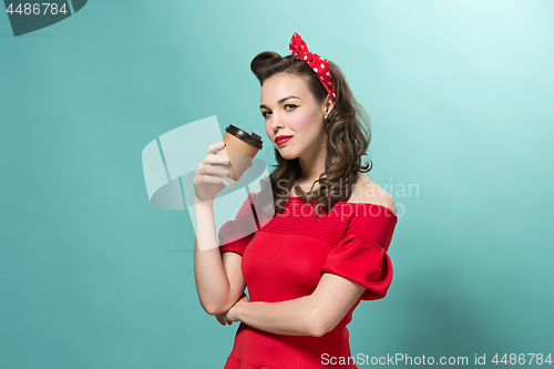 Image of Beautiful young woman with pinup make-up and hairstyle. Studio shot on white background