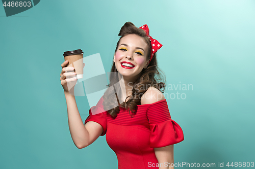 Image of Beautiful young woman with pinup make-up and hairstyle. Studio shot on white background