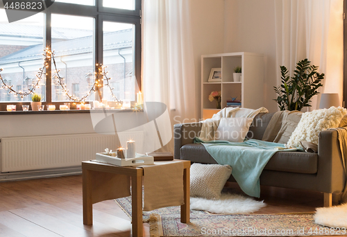 Image of living room decorated by christmas garland at home