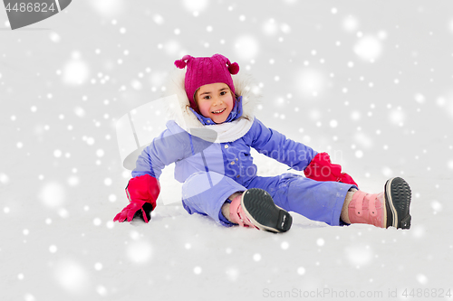 Image of happy little girl in winter clothes outdoors