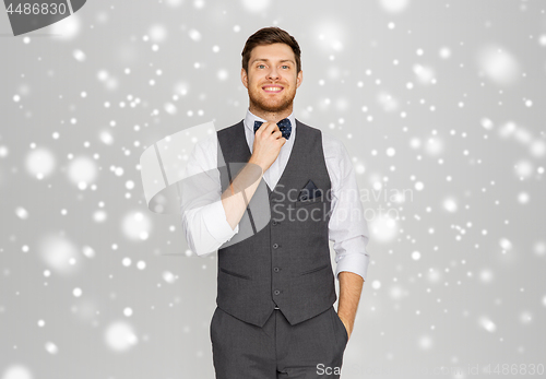 Image of happy man in festive suit dressing for party