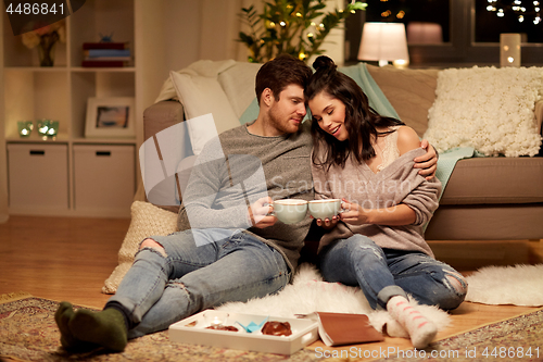 Image of happy couple drinking cacao at home