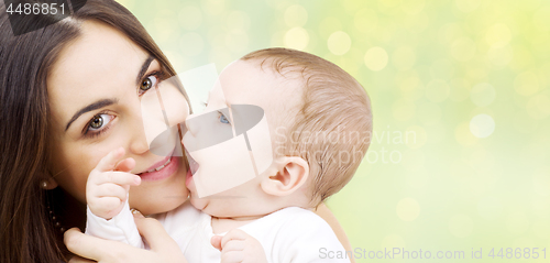 Image of close up of mother and baby over lights