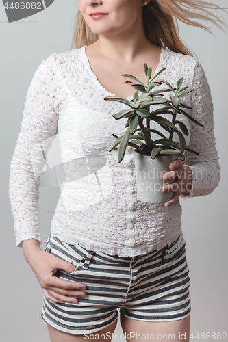 Image of Young woman holding a beautiful Panda plant