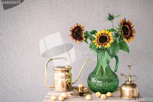 Image of Bouquet of sunflowers and brass home decor