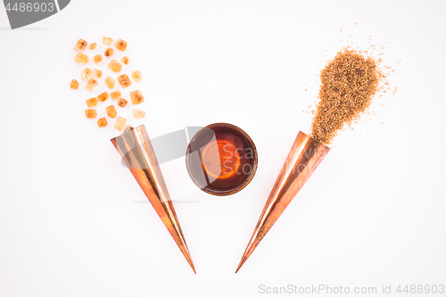 Image of Cup of tea and copper cones with sugar