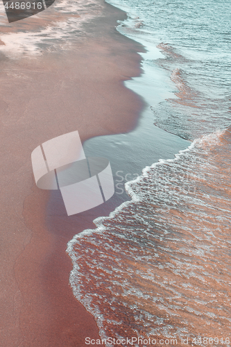 Image of Calm waves running over sand coast