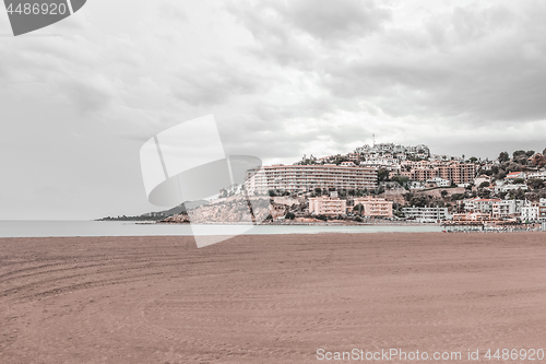 Image of View over empty beach and hotels