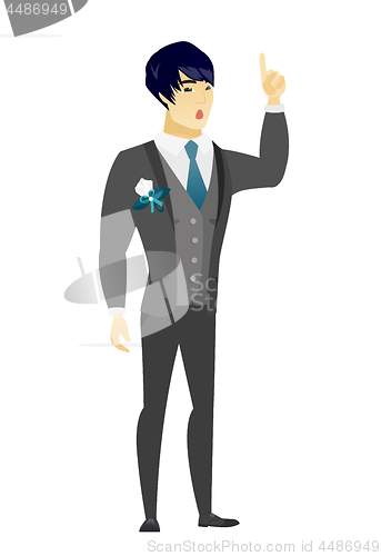 Image of Groom with open mouth pointing finger up.