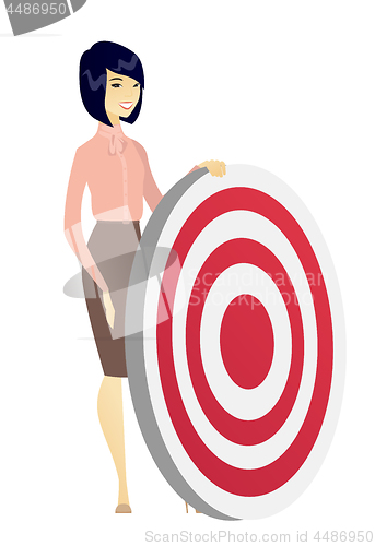 Image of Young business woman and dart board.