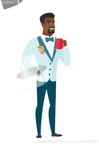 Image of Young african-american groom holding cup of coffee