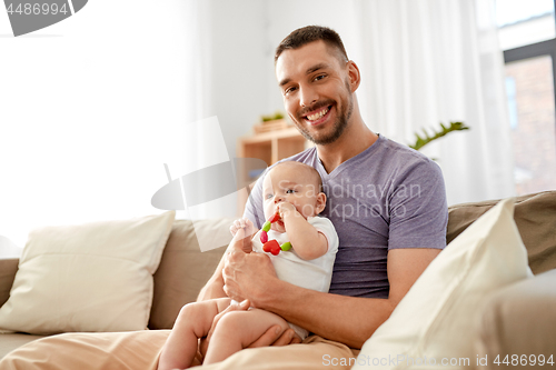 Image of happy father with little baby daughter at home