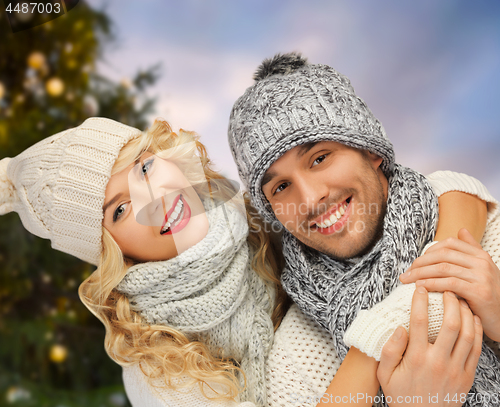 Image of happy couple hugging over christmas tree