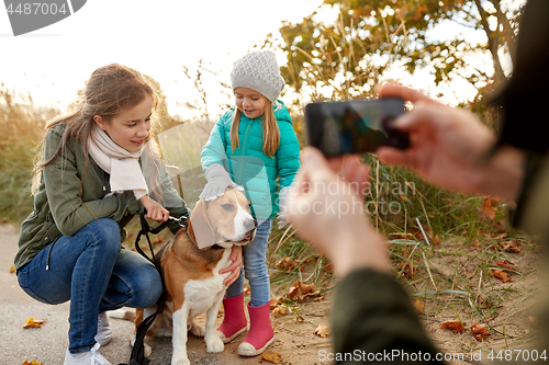 Image of family photographing by smartphone on autumn beach