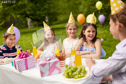 Image of happy kids on birthday party at summer garden