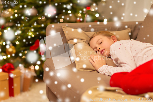 Image of girl sleeping on sofa at christmas