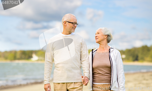 Image of happy senior couple over beach background