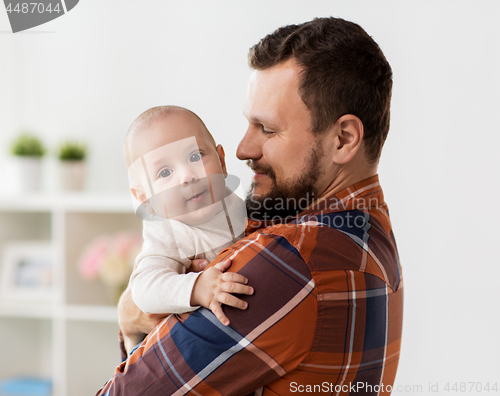 Image of happy father with little baby boy at home