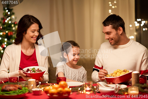 Image of happy family having christmas dinner at home