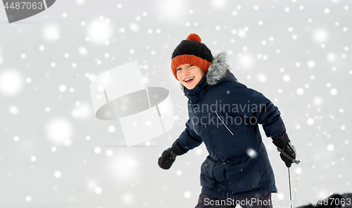 Image of happy little boy with sled in winter outdoors