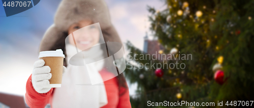 Image of woman with coffee over christmas tree in tallinn