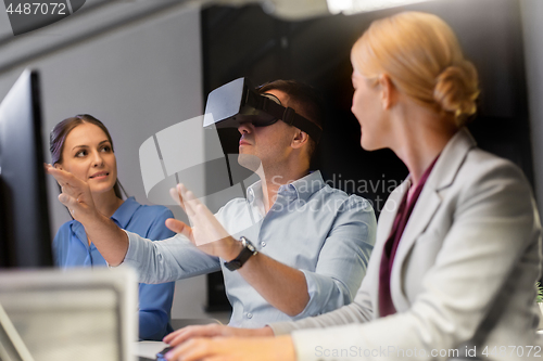 Image of business team with computer working late at office