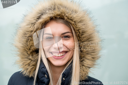 Image of portrait of young blonde girl wearing winter jacket