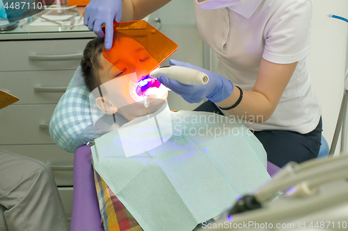 Image of Orthodontist examining boy mouth