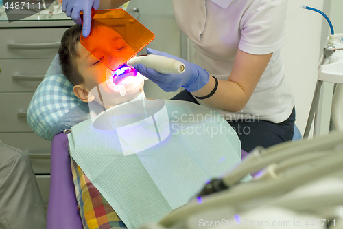 Image of Orthodontist examining boy mouth