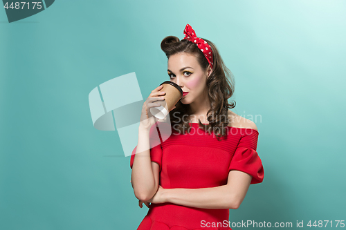 Image of Beautiful young woman with pinup make-up and hairstyle. Studio shot on white background